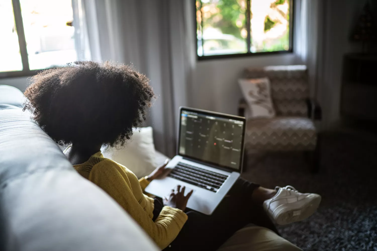 A person looks up health information on their laptop at home while isolating after an exposure to an infectious disease.