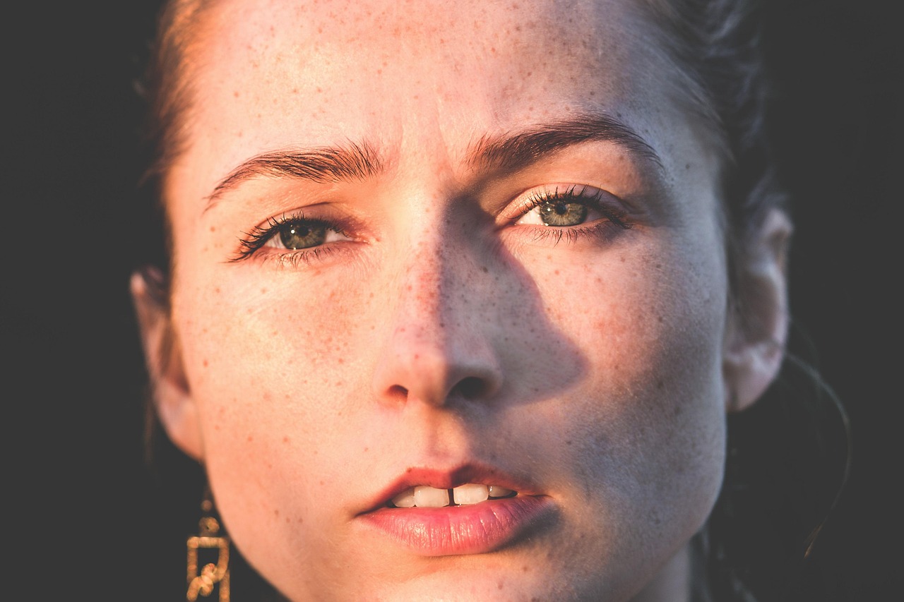 A woman looking tired and pale, symbolizing nutrient deficiency symptoms.