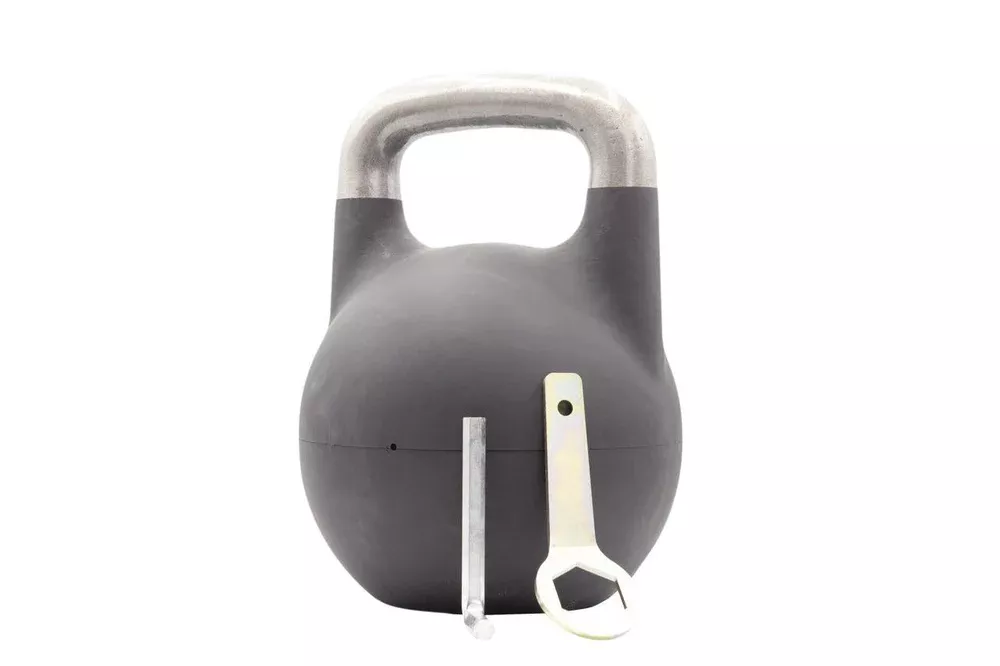 A competition-style adjustable kettlebell with a polished metal handle and adjustment tools.