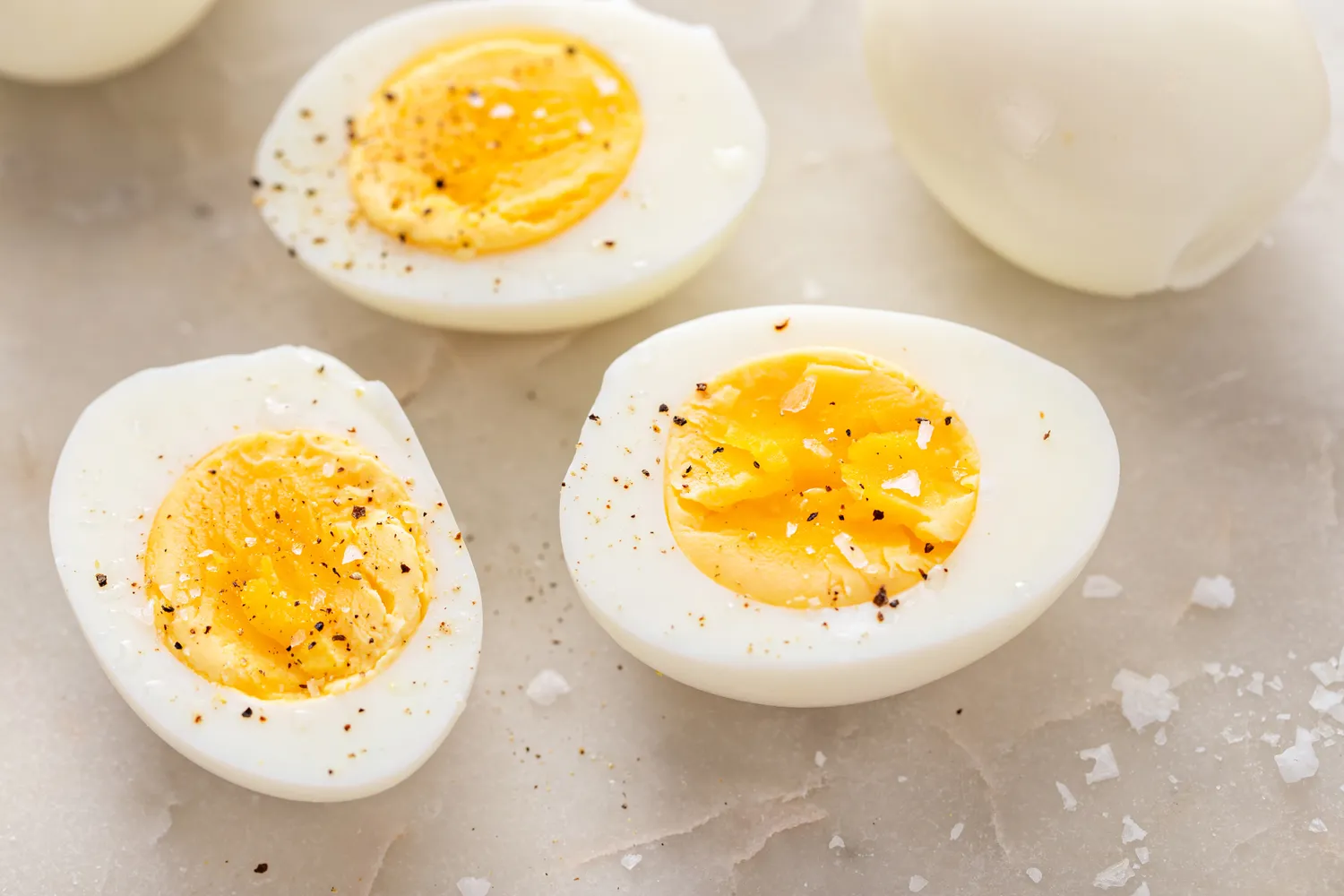 Hardboiled eggs cut in half and seasoned with salt and pepper.