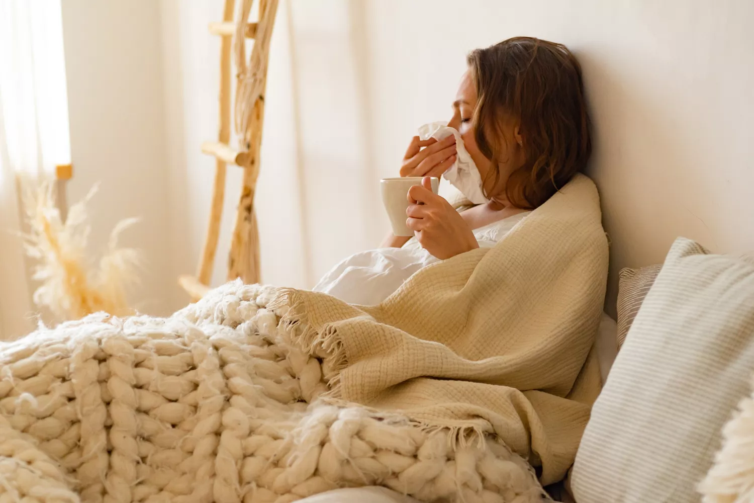 A woman in bed showing signs of physical discomfort and fatigue associated with electrolyte imbalance.