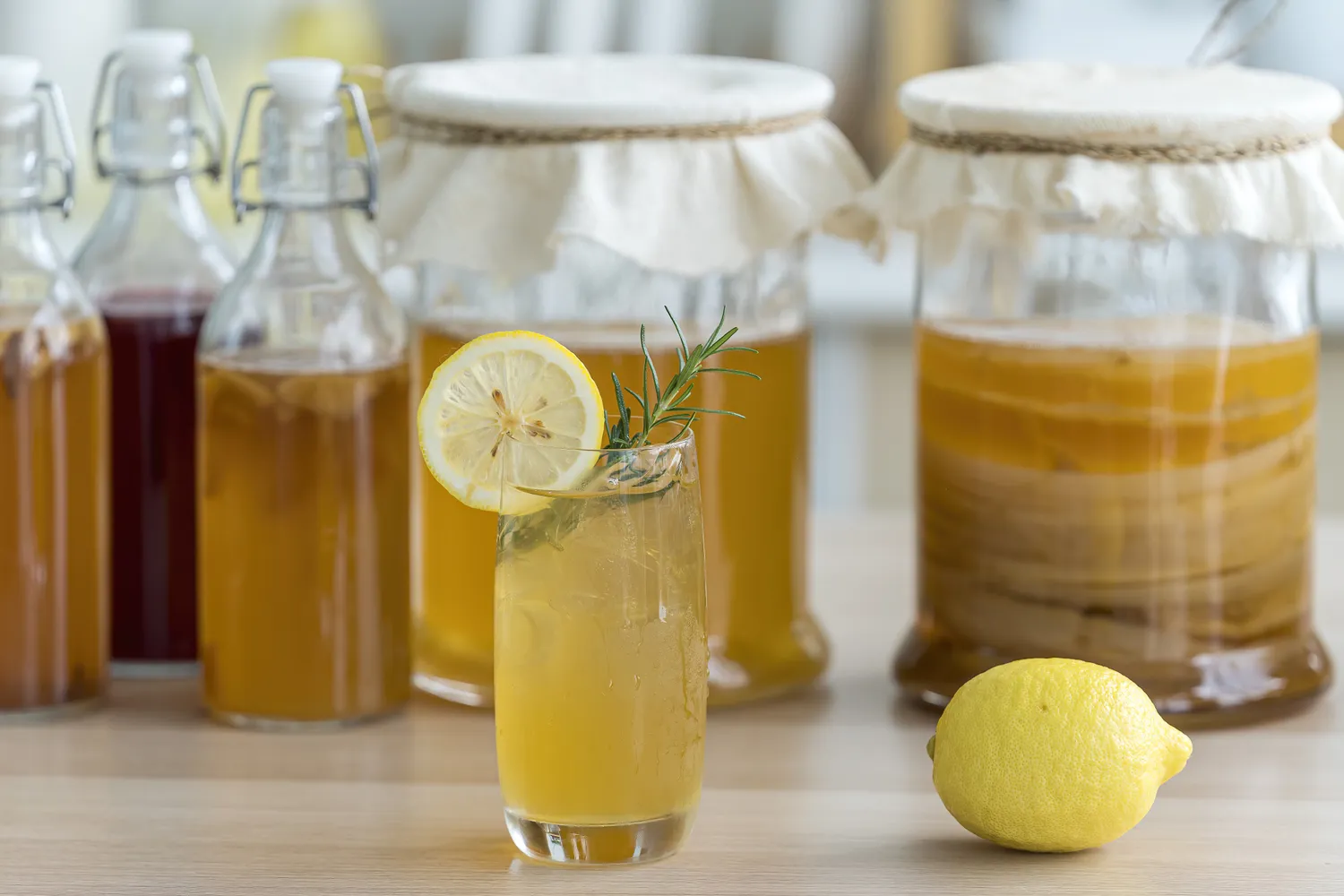 A glass of kombucha showing fermentation bubbles.