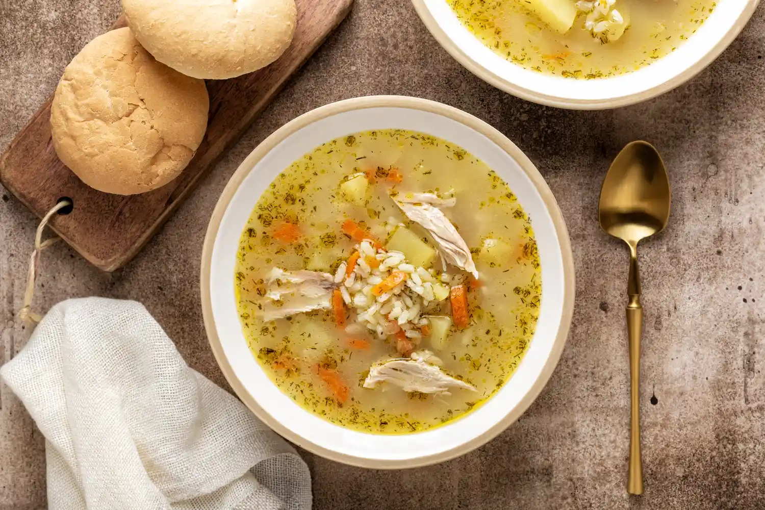 Chicken and rice soup in a ceramic bowl.