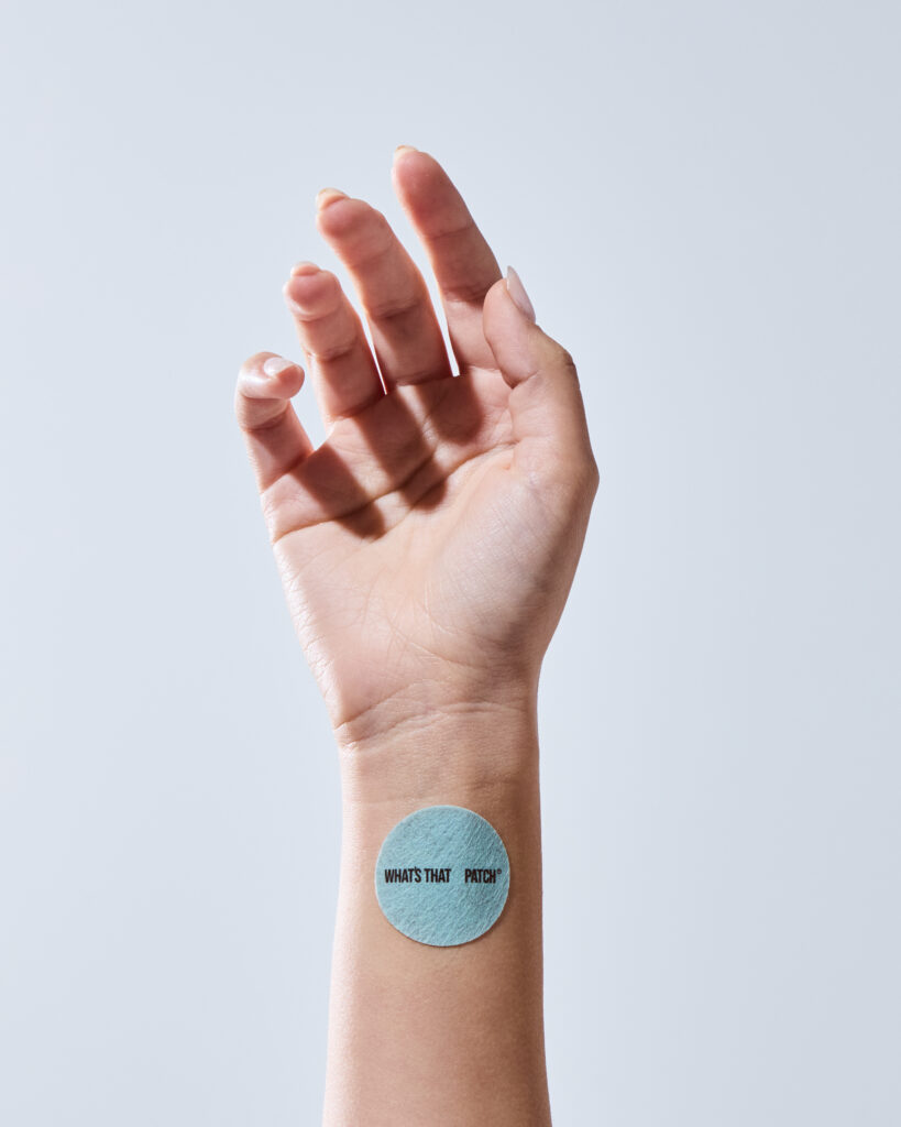 Close-up showing the proper application of a vitamin patch on a recommended skin area.