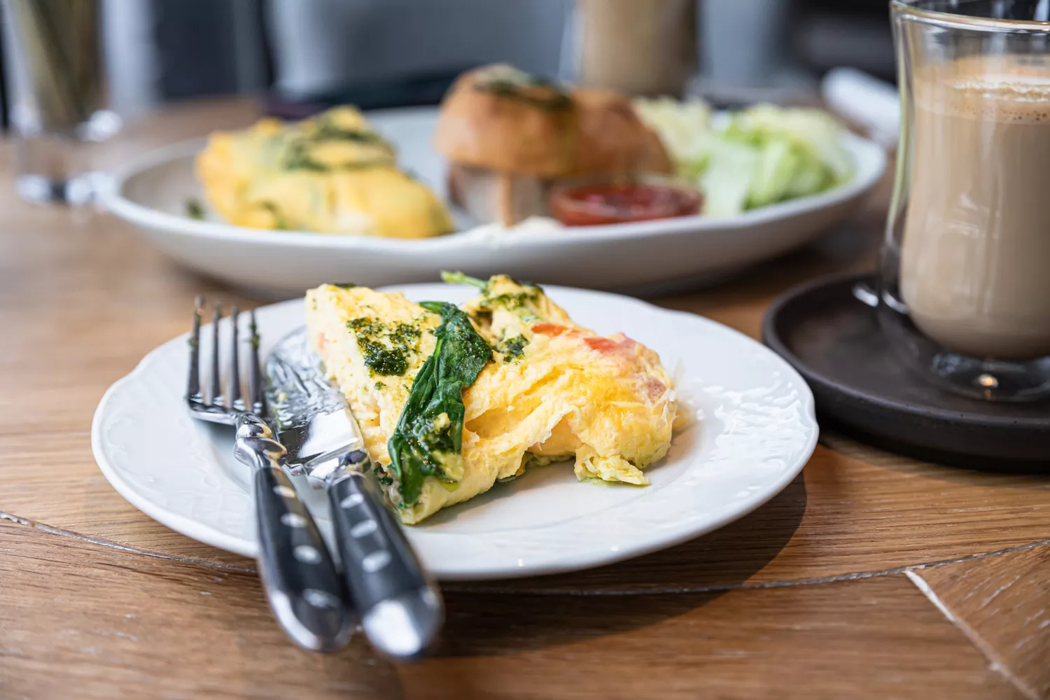 A protein-rich spinach omelet served on a white plate.