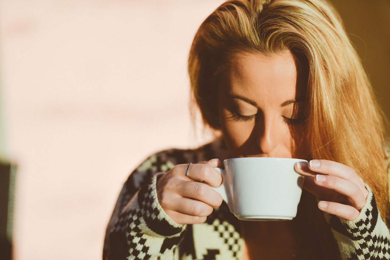 A person looking refreshed while drinking a healthy beverage