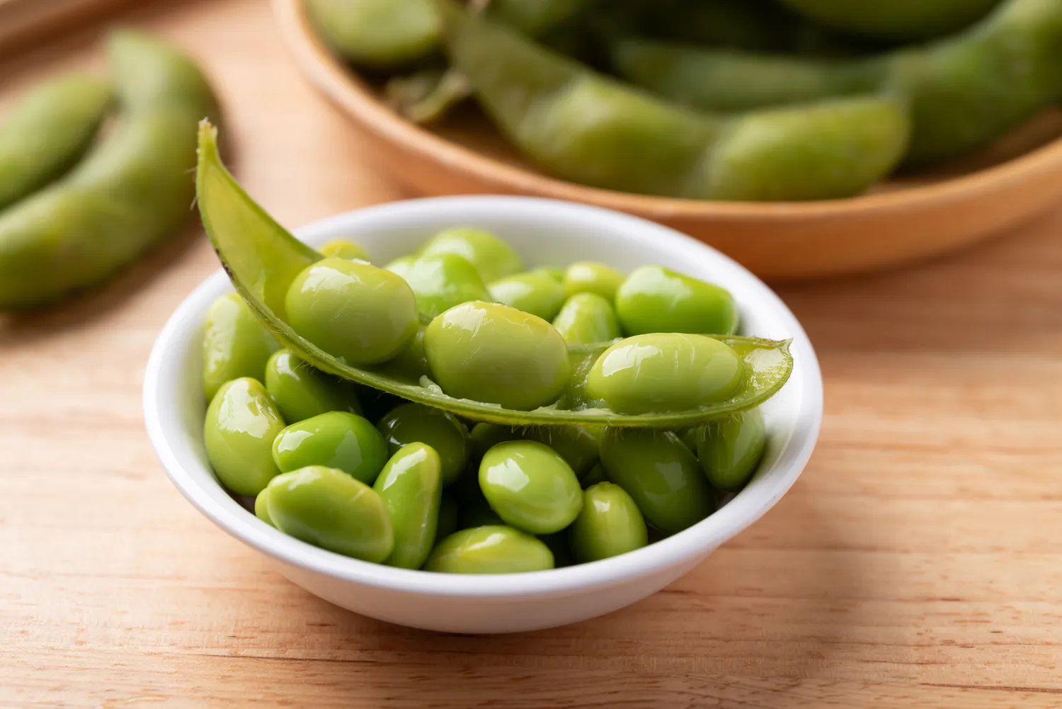 A bowl of fresh edamame pods and beans.