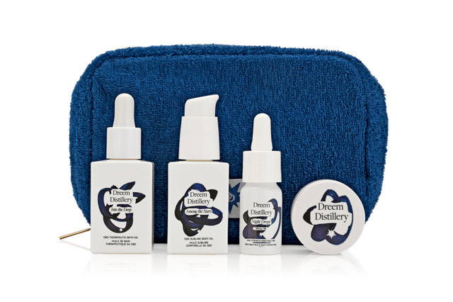A person applying a CBD topical balm to their shoulder for nightly muscle relief.