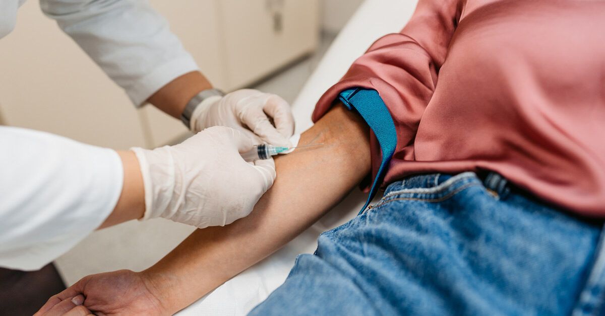 Close-up of a medical professional handling blood vials for pANCA and ASCA antibody testing.