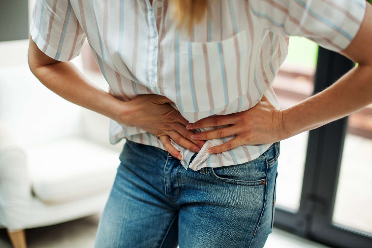 A person experiencing intestinal gas and abdominal pressure.