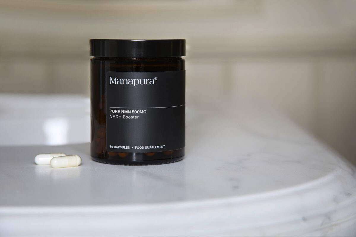 Close-up of high-purity NMN capsules in a professional clinical setting.