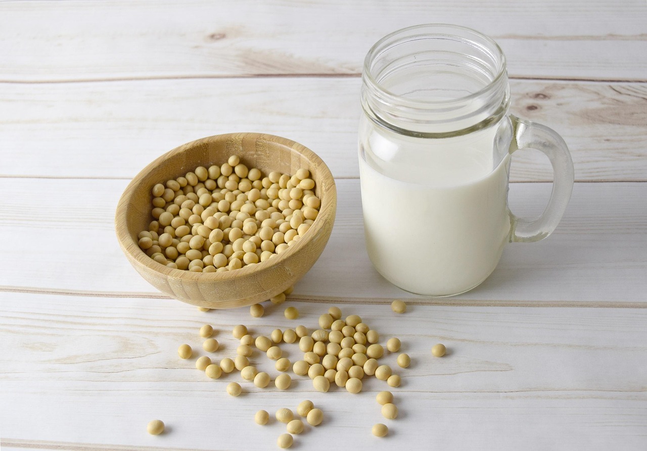 A visual comparison of dairy milk alongside various plant-based protein sources like soy and peas.