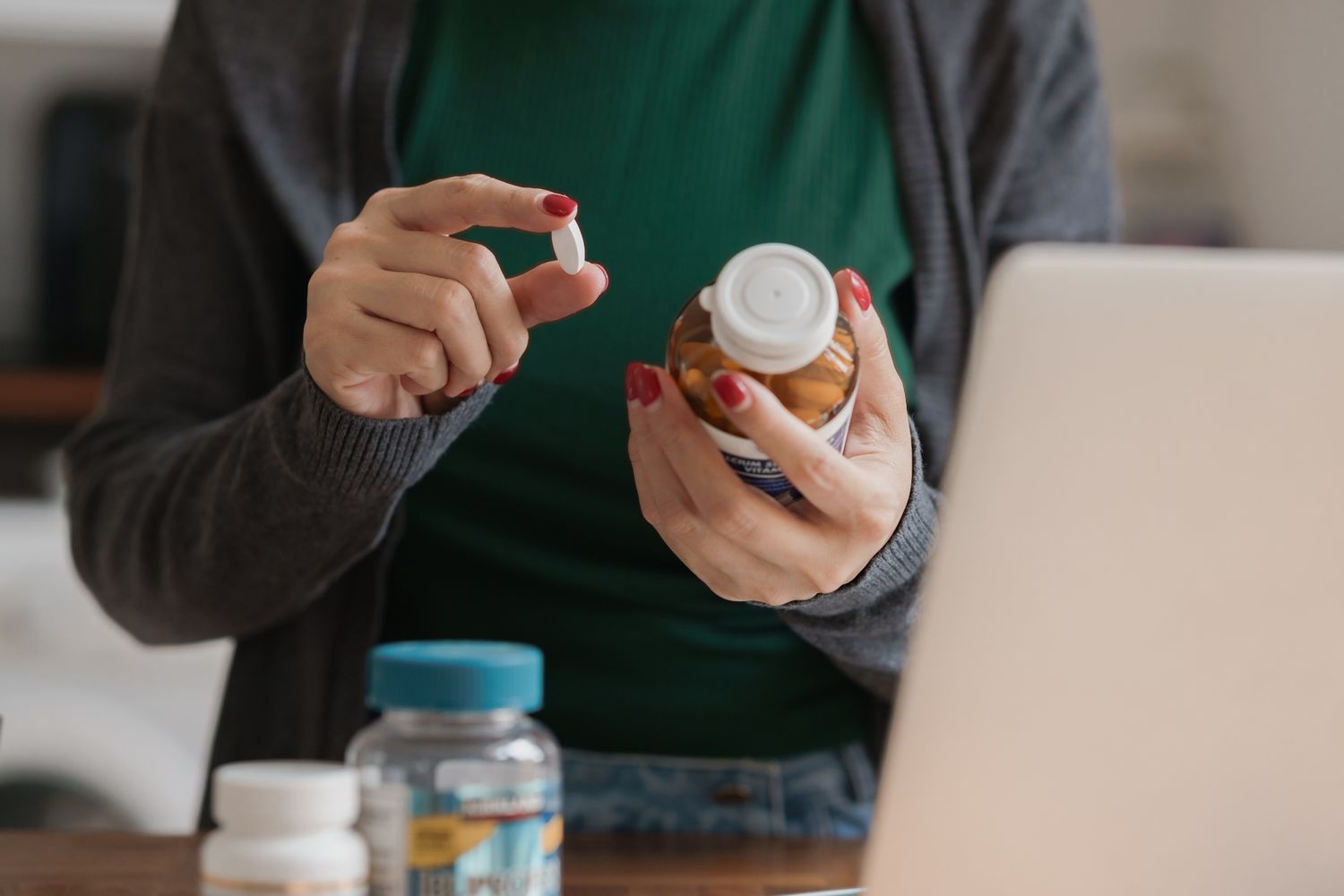 A woman holding a selection of allergy relief tablets in her hand.